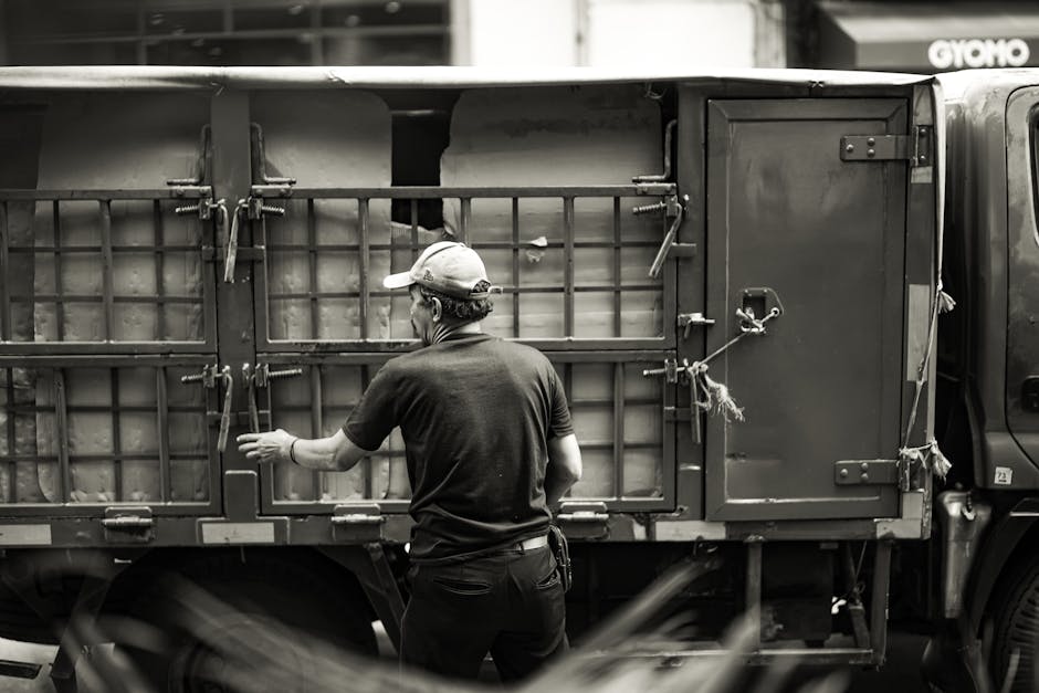 Moving company team carefully loading furniture into a large truck
