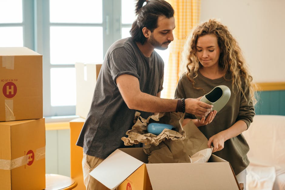 Professional movers unpacking boxes in a newly organized living room