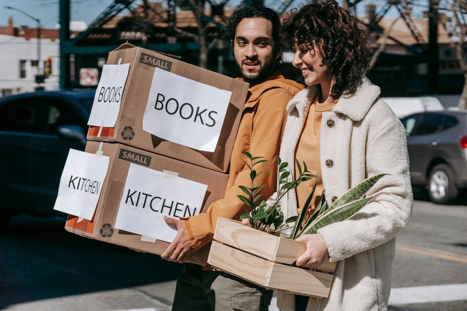 Family carrying moving boxes into their new home